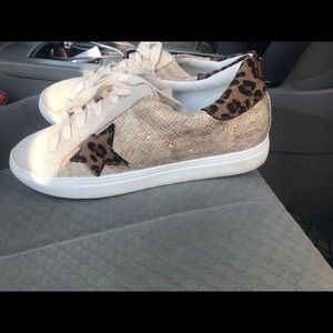 Beige sneakers. Beautiful leopard with snake skin